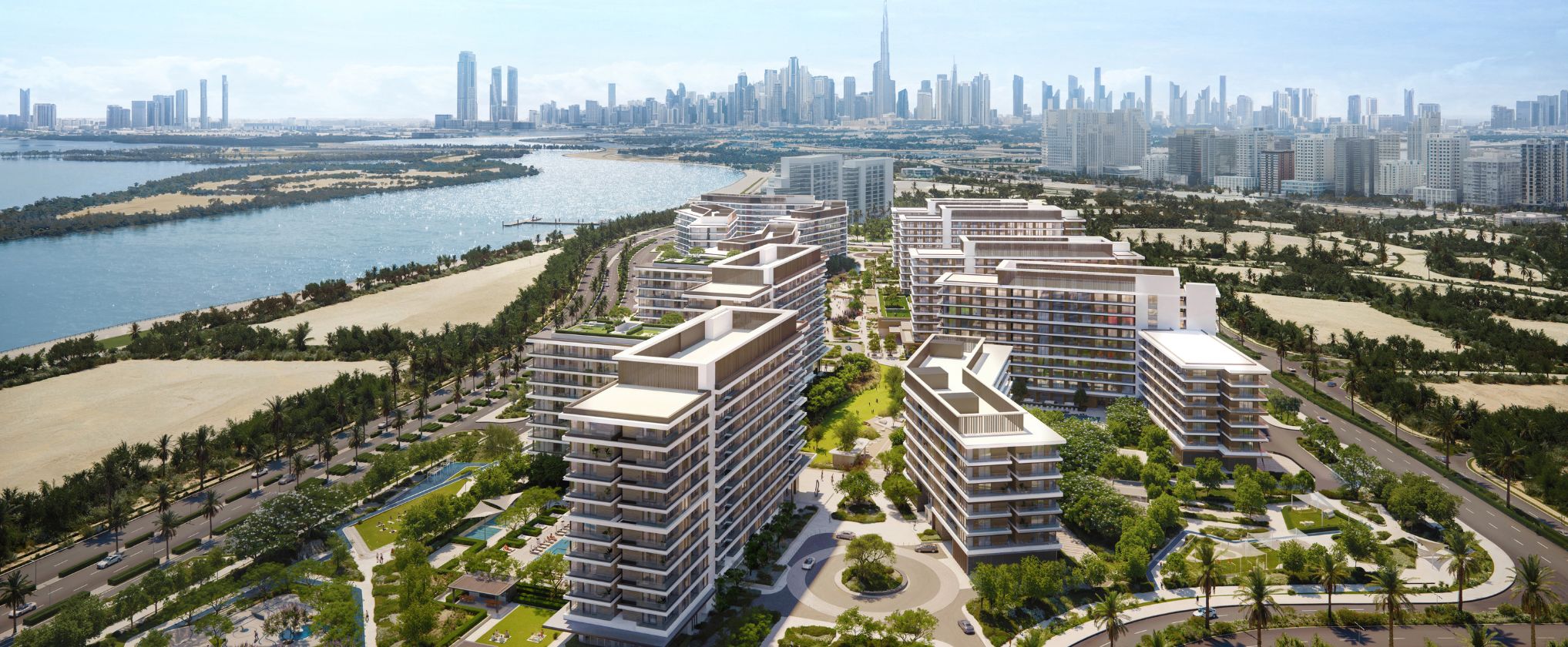 Dubai Creek Gardens at dusk — a lit swimming pool edged with loungers and pergolas, deep planting and mature trees below a low-rise residential building with planted balconies